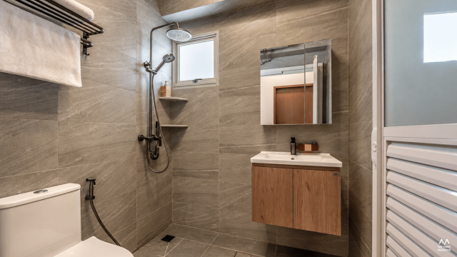 141A McNair 141A McNair HDB bathroom with grey stone-look tiles and a glass shower enclosure