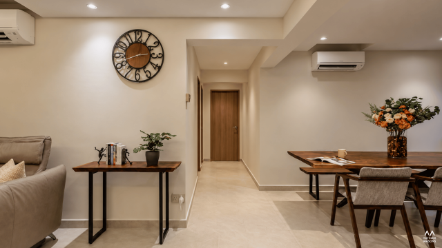 171 Ang Mo Kio 171 Ang Mo Kio HDB dining area with a round wall clock, wood finishes and a minimalist dining table