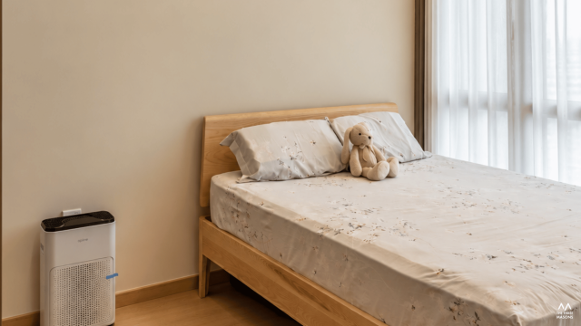 3 Dairy Farm 3 Dairy Farm condominium bedroom with a neutral upholstered bed and warm accent lighting
