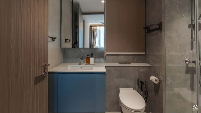65 Copen Grand 65 Copen Grand condominium bathroom with a blue vanity cabinet and grey stone-look finishes