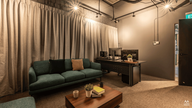 Dandelion Studios Dandelion Studios interior with warm pendant lighting and a dark lounge seating area