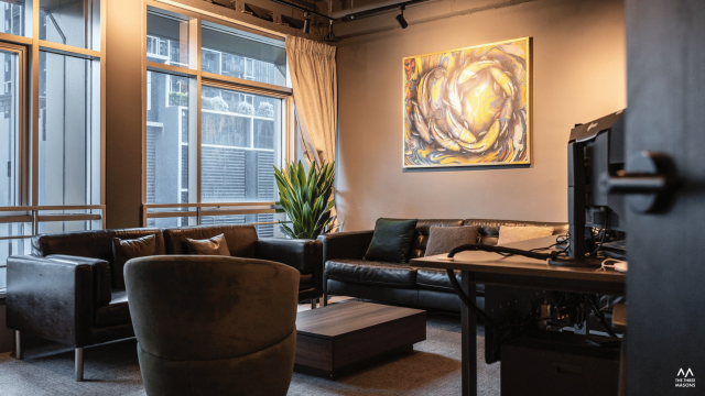 Dandelion Studios Dandelion Studios workspace with a wood desk, shelving and contemporary wall art