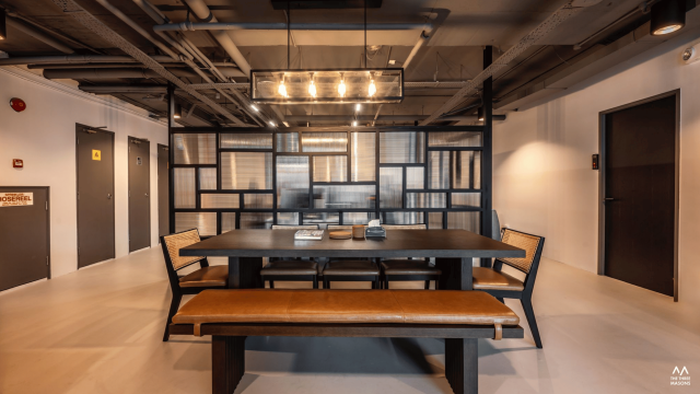 Dandelion Studios Dandelion Studios meeting area with a long wood table and industrial-style lighting