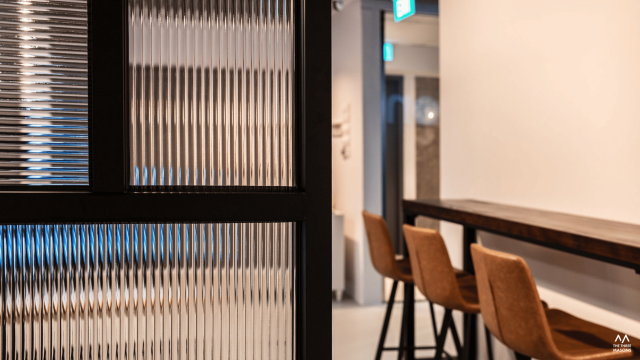 Dandelion Studios Dandelion Studios interior with vertical feature panels and warm architectural lighting