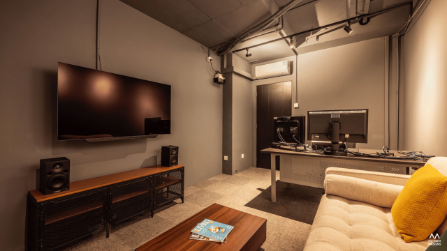 Dandelion Studios Dandelion Studios commercial interior with a television wall and dark contemporary finishes