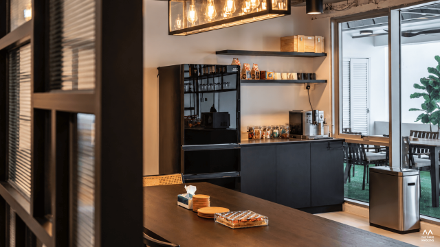 Dandelion Studios Dandelion Studios interior featuring dark cabinetry, display shelving and warm lighting